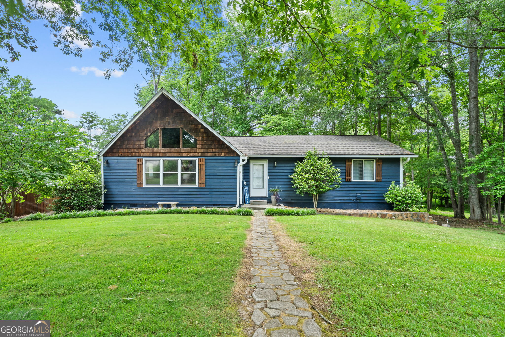 a front view of a house with a yard