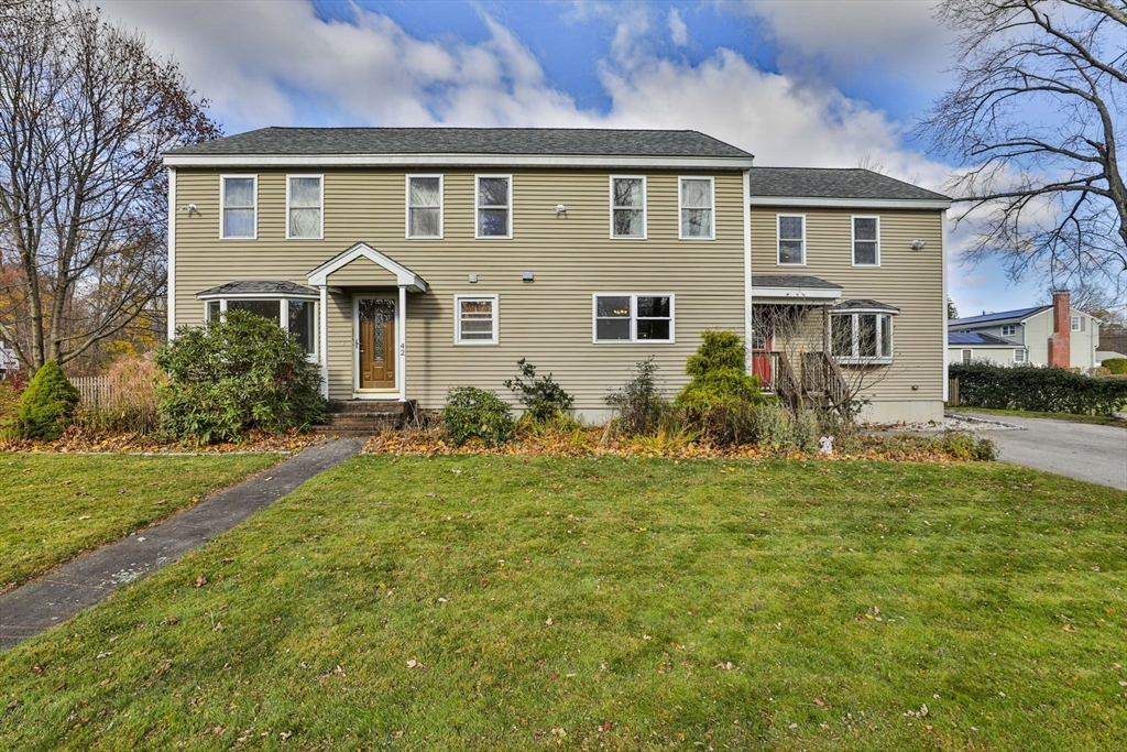 a front view of house with yard and green space