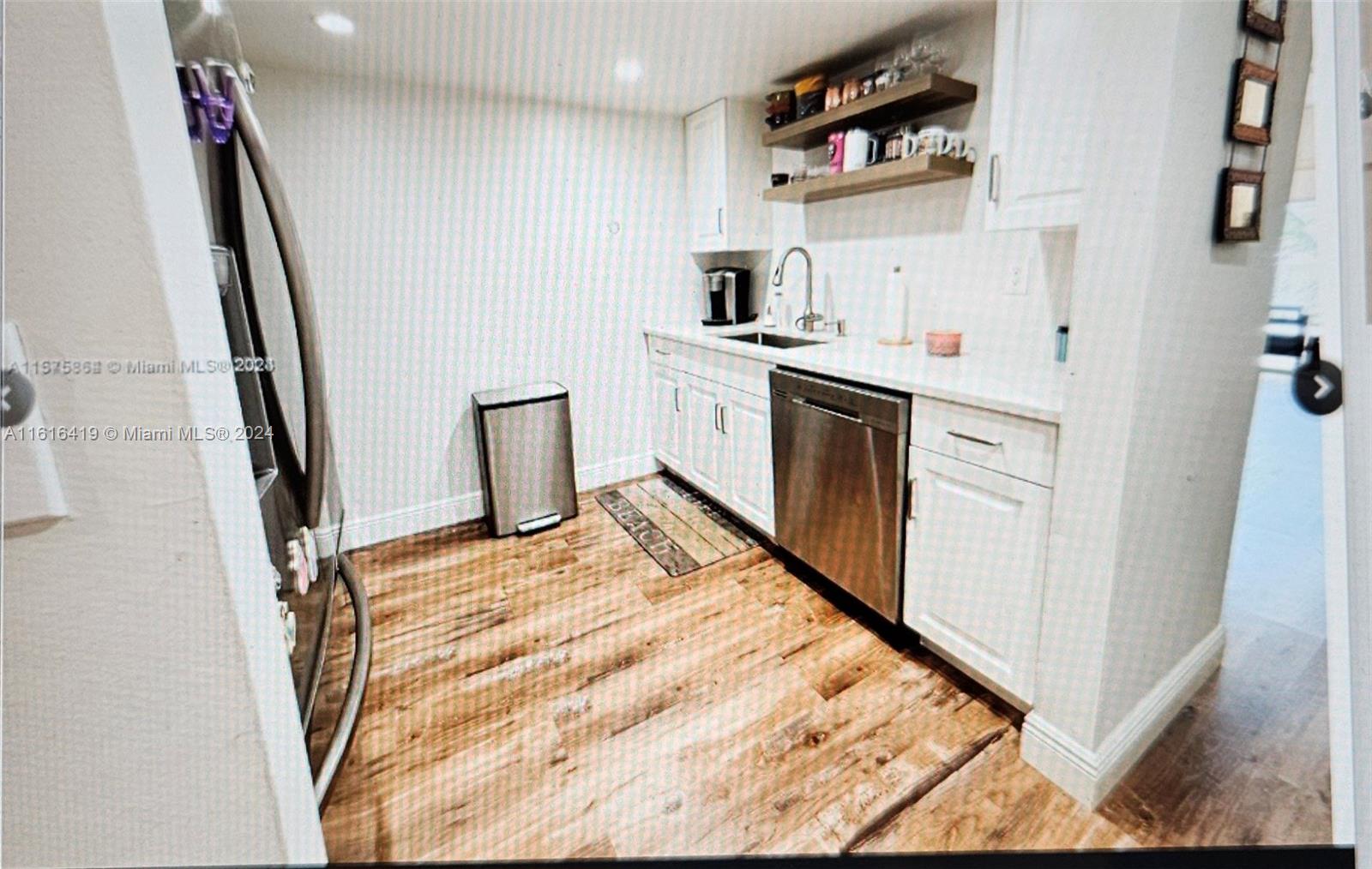 a kitchen with white cabinets and white appliances