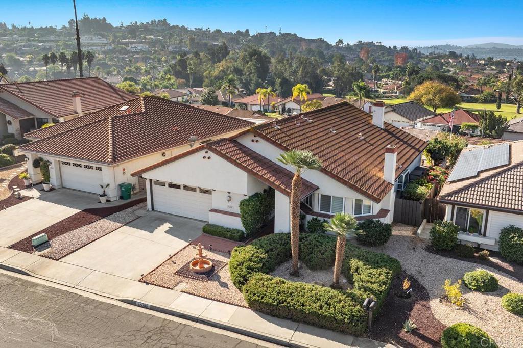 an aerial view of a house with a yard swimming pool and mountain view