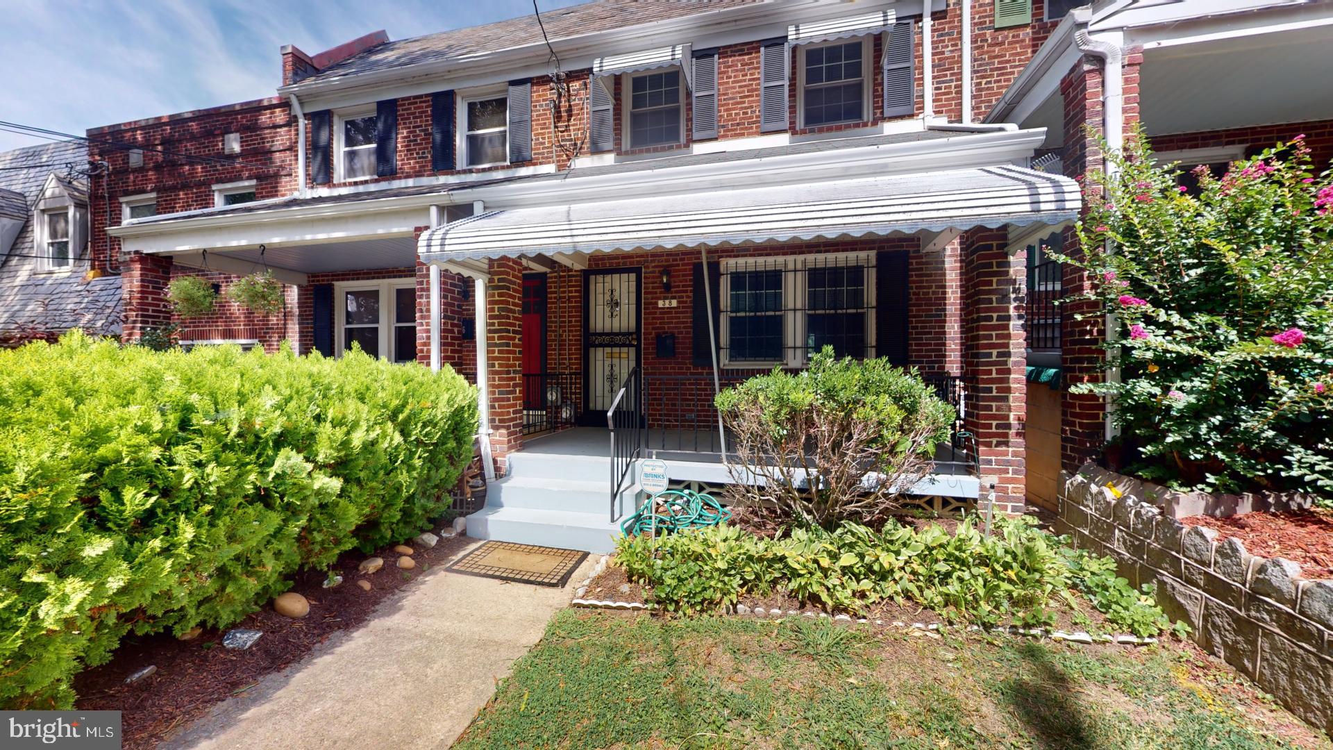 front view of a brick house with a large window