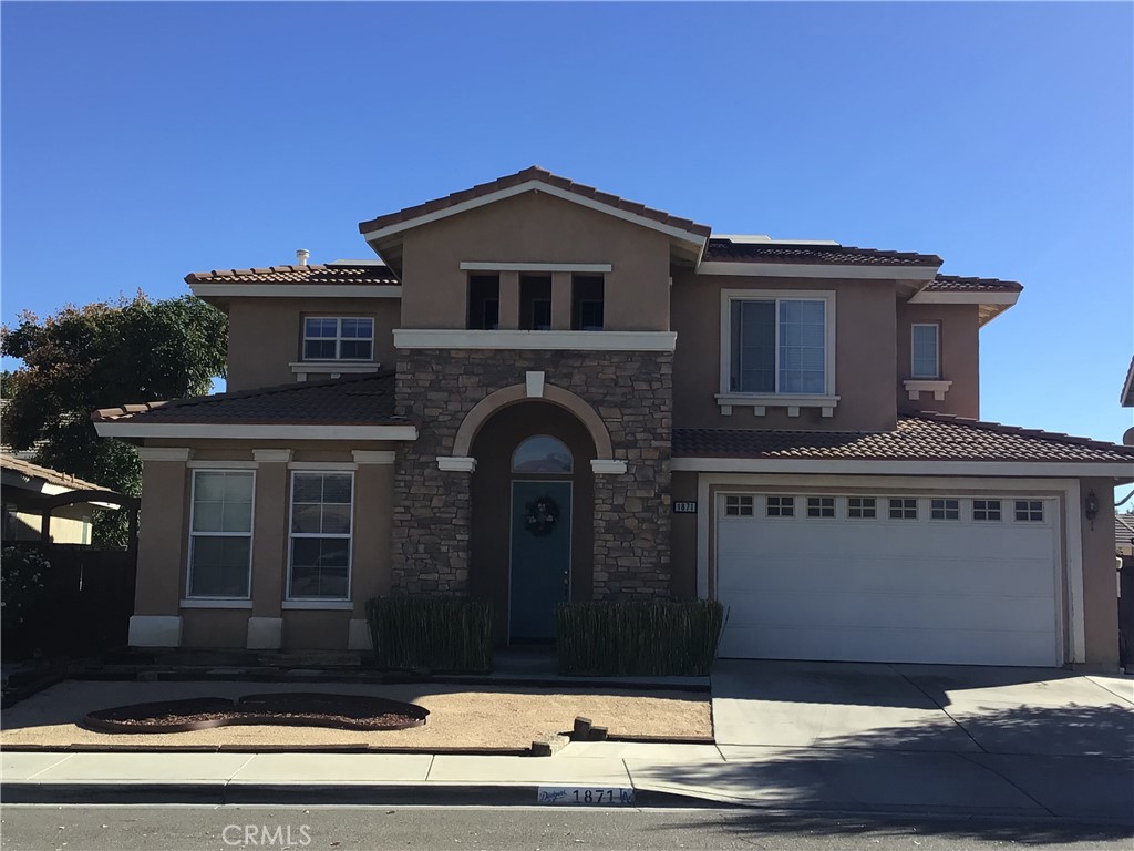 a front view of a house with garage