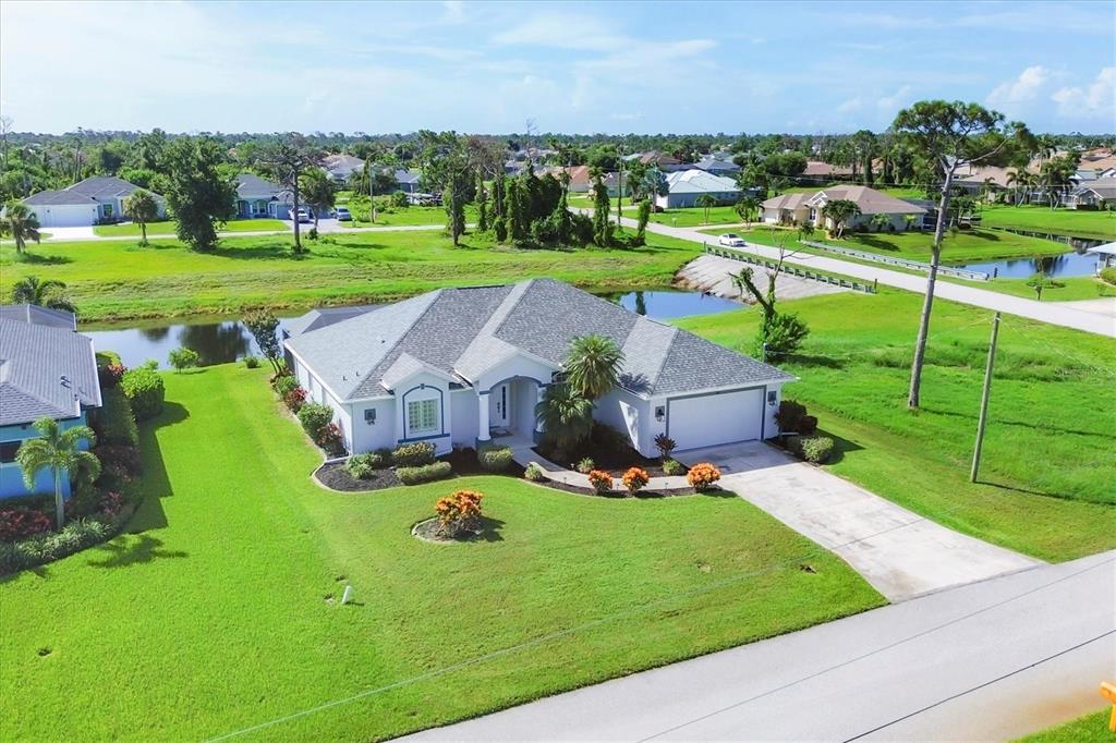 an aerial view of a house with garden space and street view