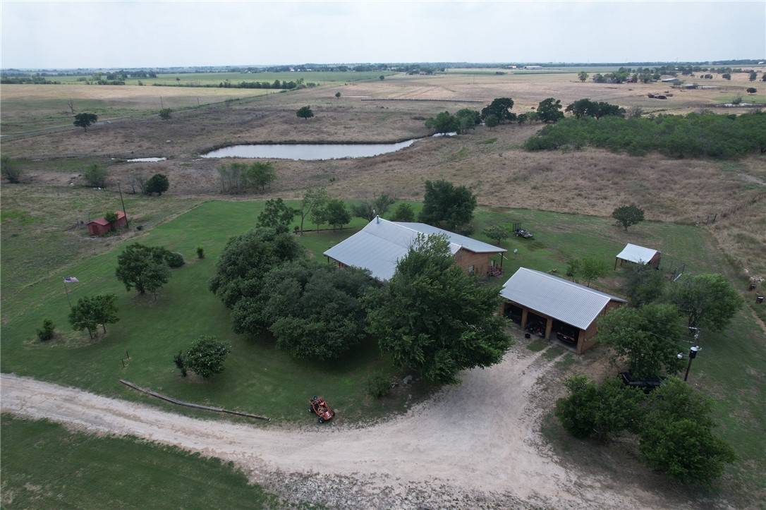 an aerial view of a house with a garden and lake view