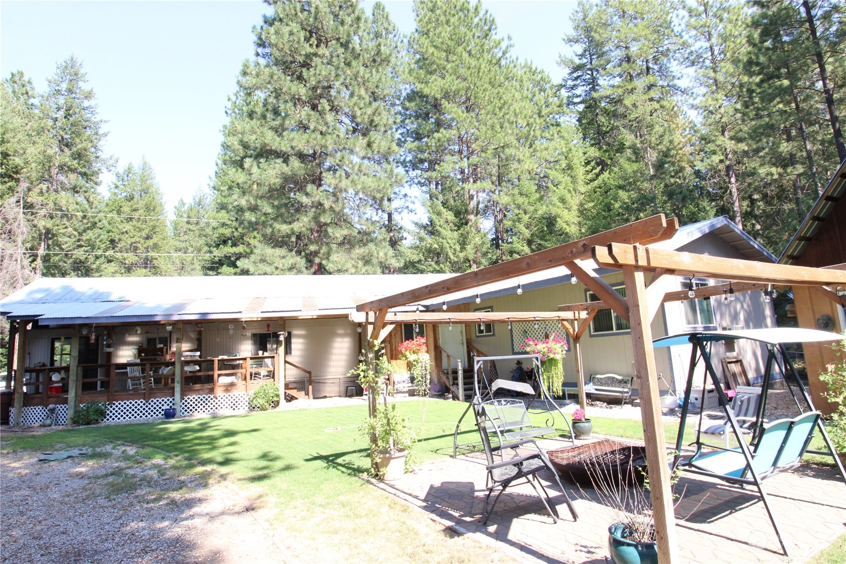 a view of a house with backyard porch and sitting area