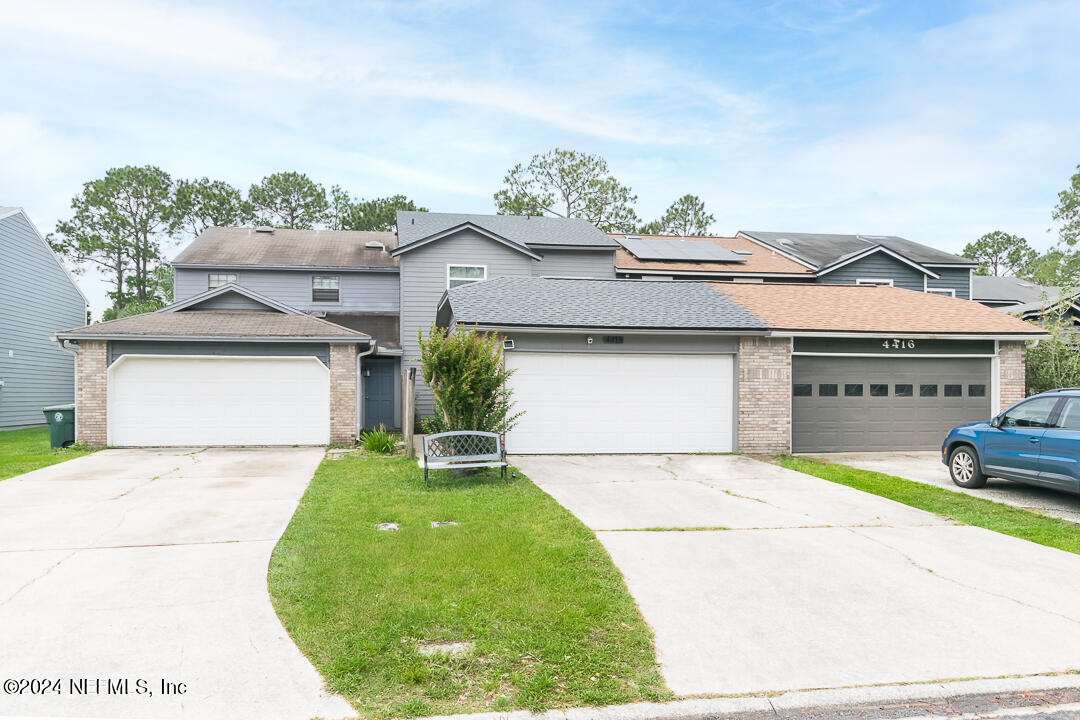 a view of a house with a yard and garage