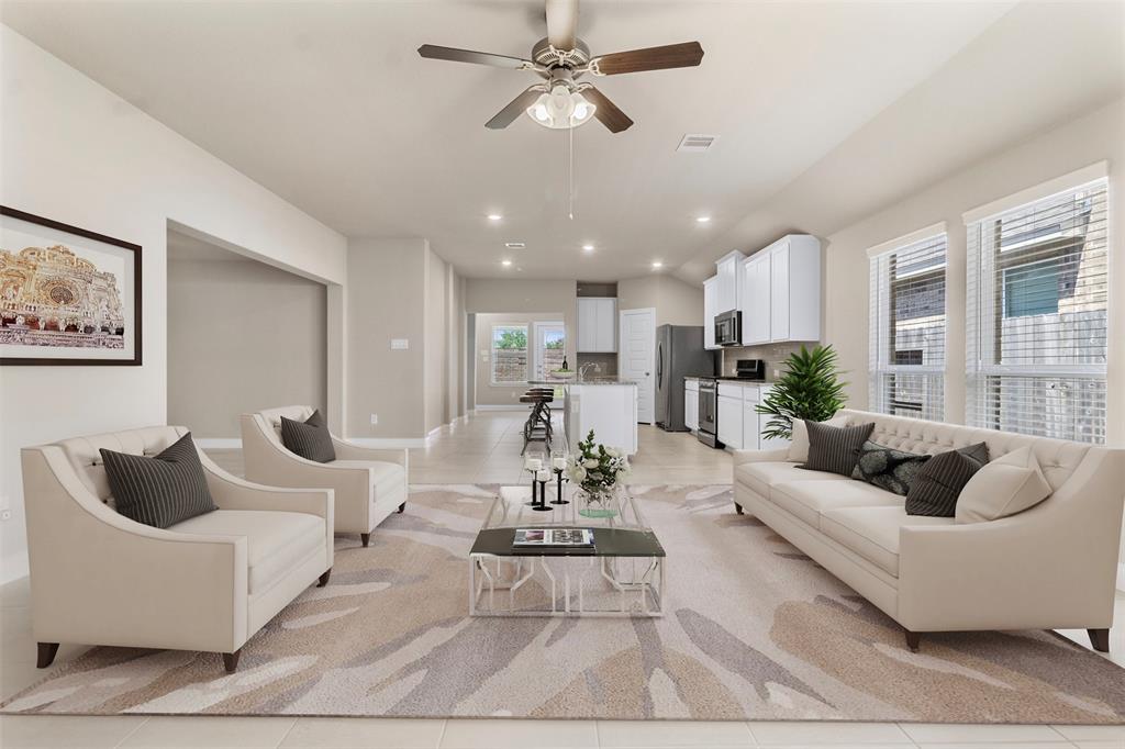 a living room with furniture and kitchen view