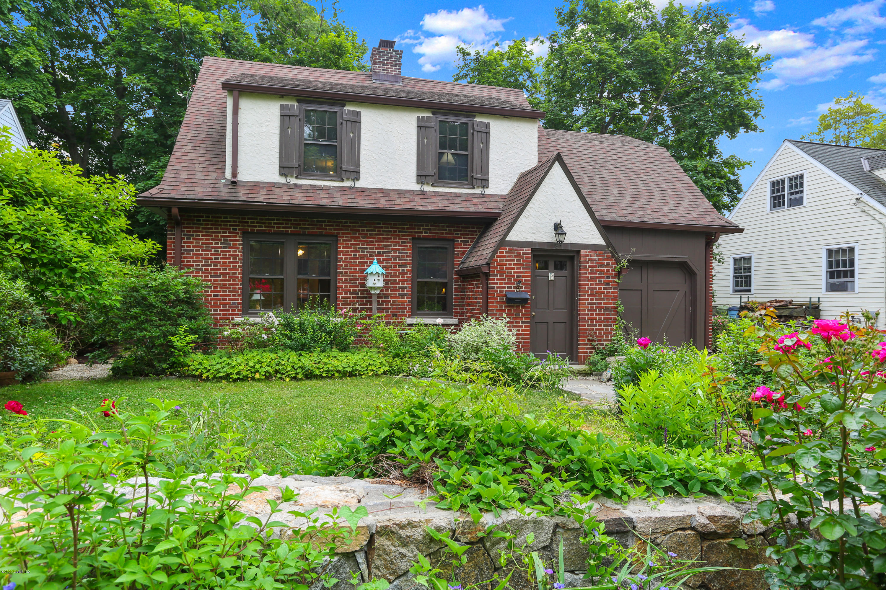 a front view of a house with garden