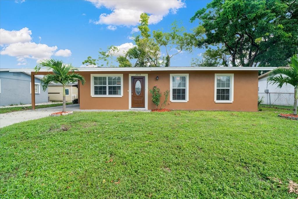 a view of a house with yard and a tree