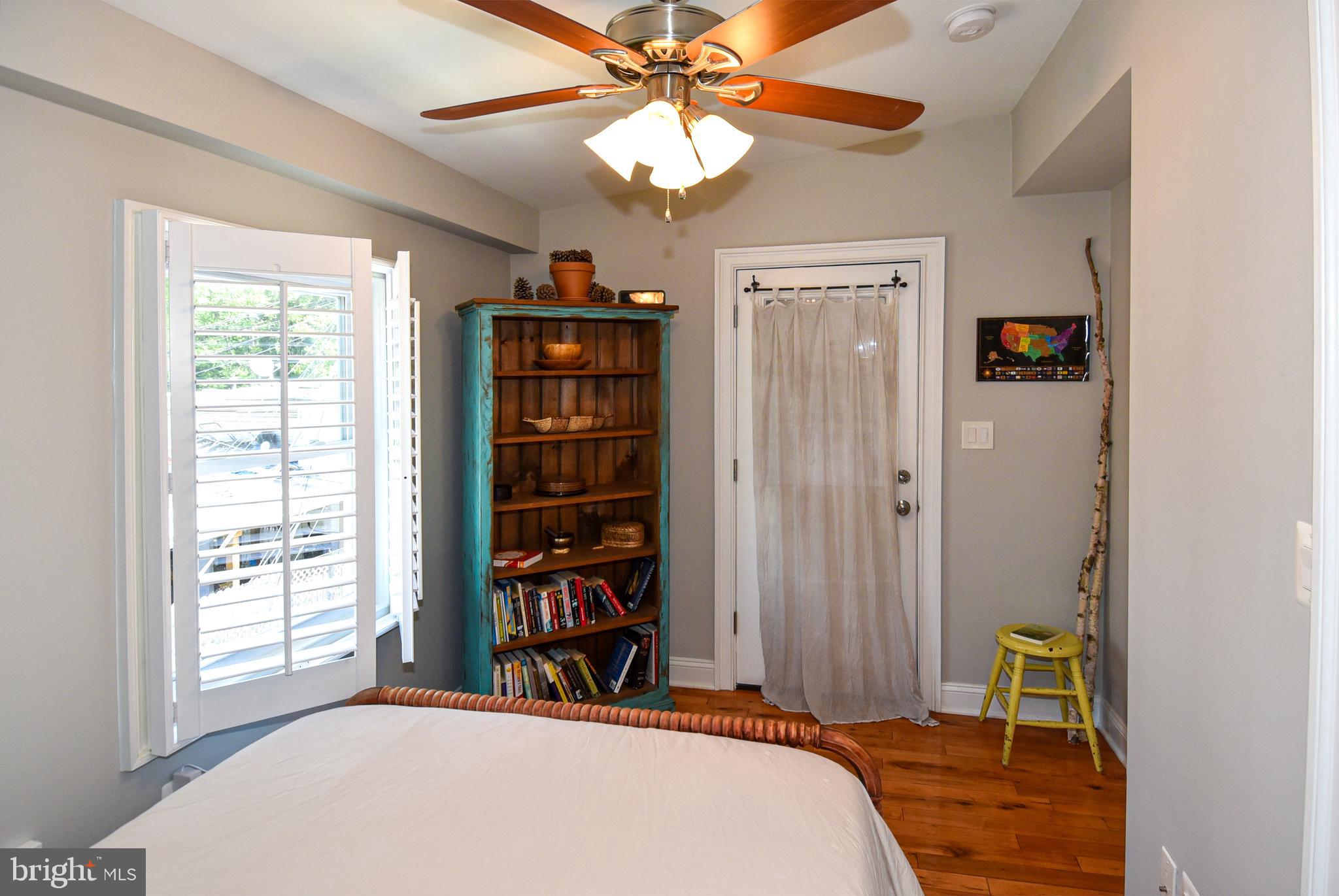 a bedroom with a bed a chandelier and a window