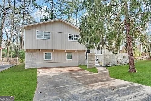 a house that has a tree in front of the house