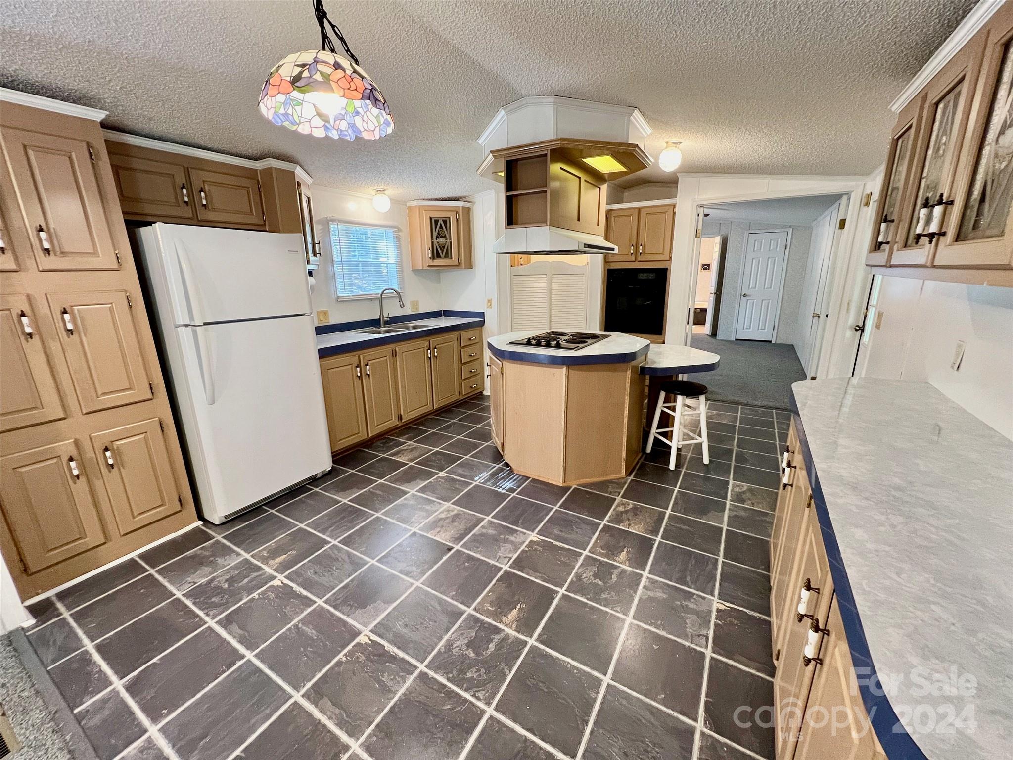 a kitchen with a sink a stove and cabinets