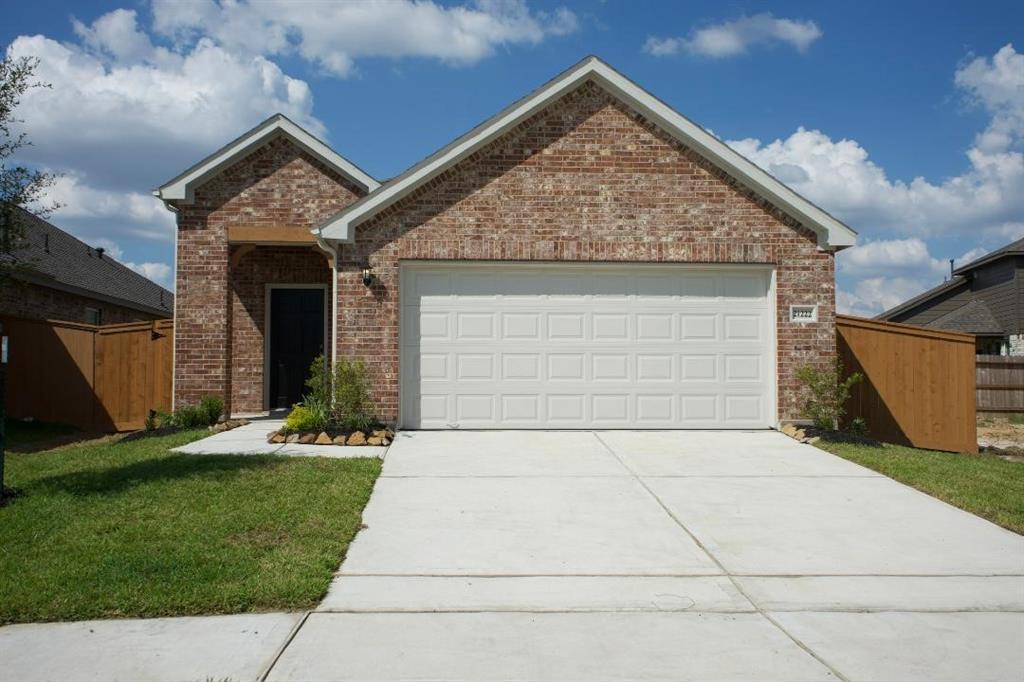 a front view of house with a garden