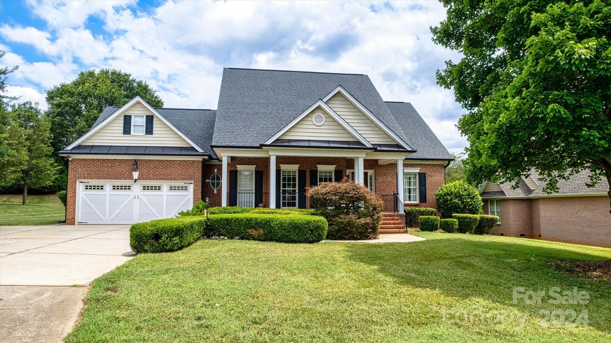 a front view of a house with a yard and porch