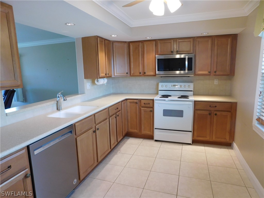 a kitchen with a sink stove and microwave