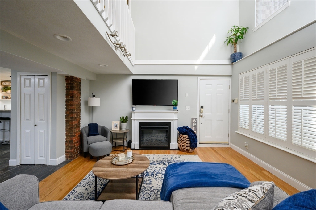 a living room with furniture fireplace and window