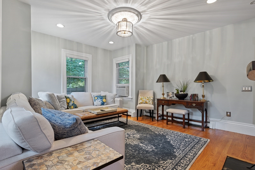 a living room with furniture rug and window