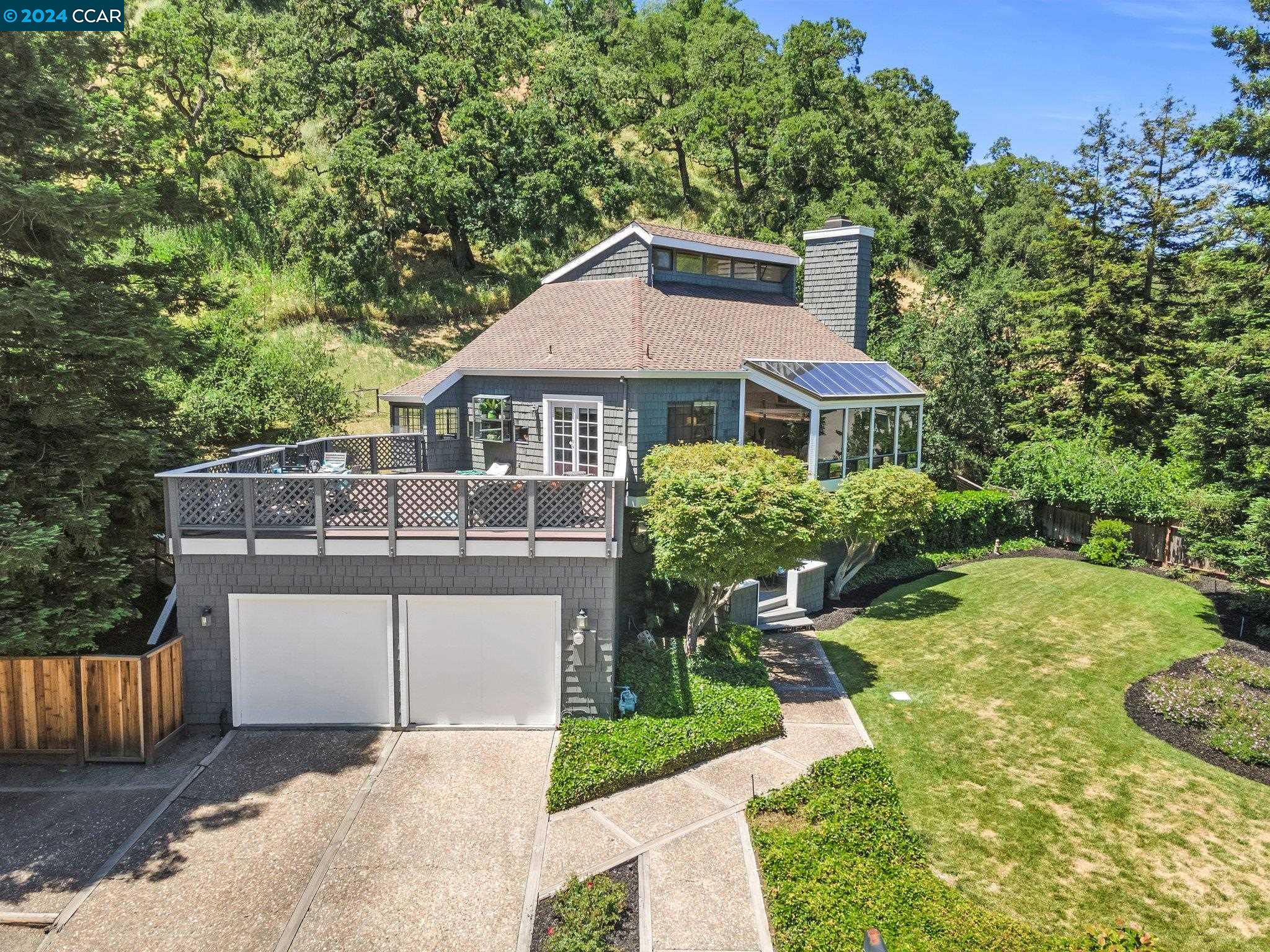 a view of a house with a yard and sitting area