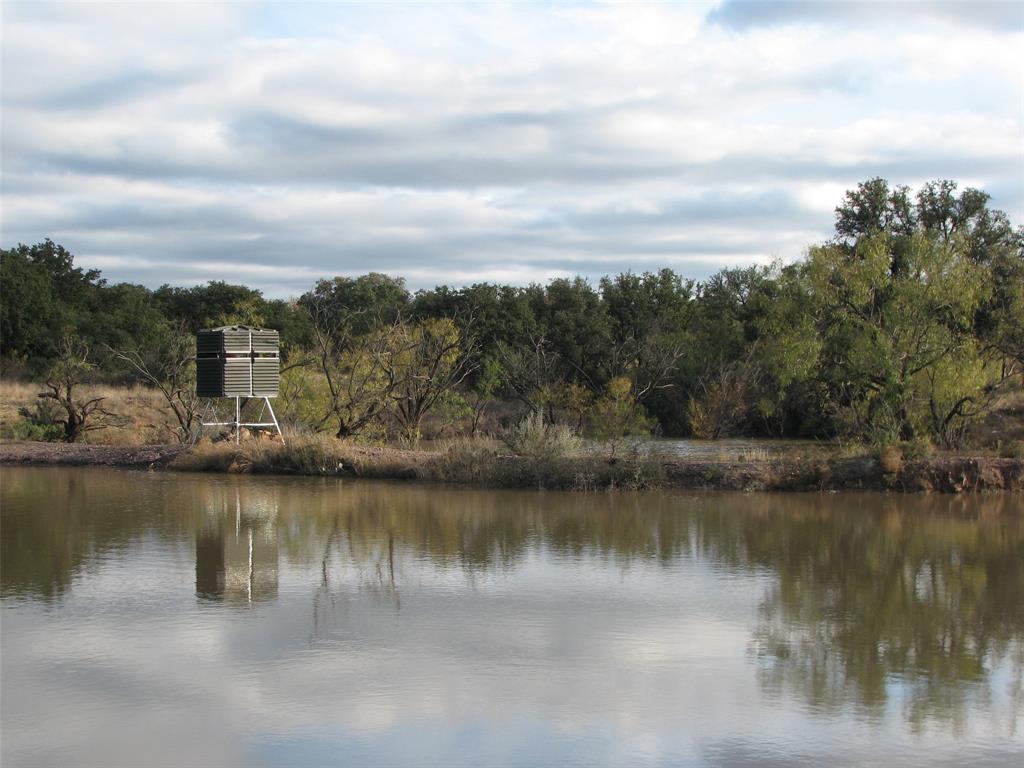 a view of a lake with houses in the back