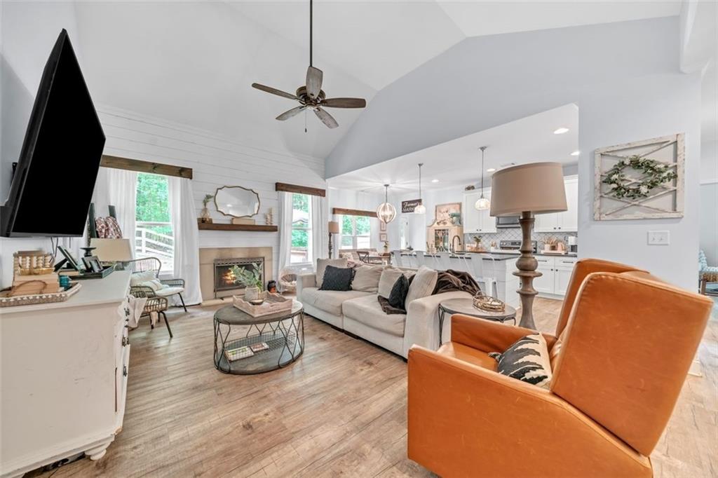 a living room with furniture a fireplace and a flat screen tv