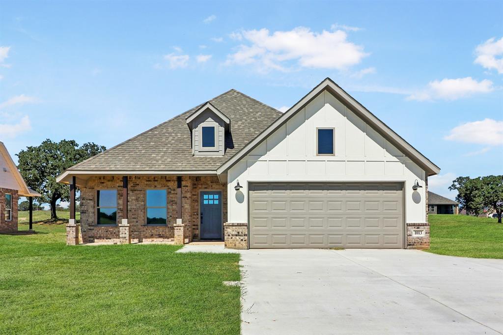 a front view of house with yard and green space