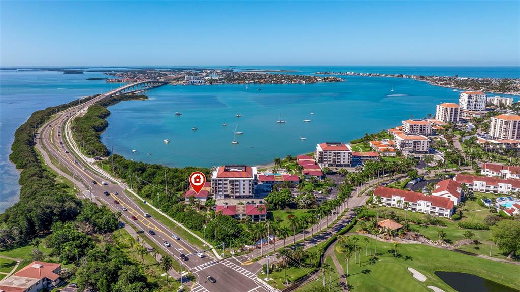 an aerial view of lake and residential houses with outdoor space