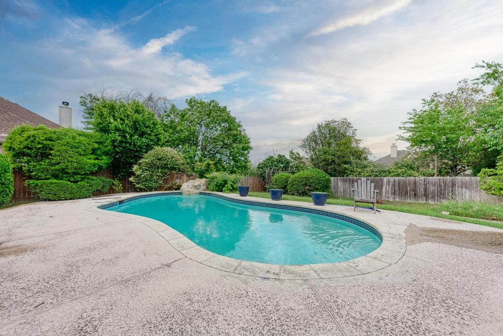 a view of a swimming pool with a yard