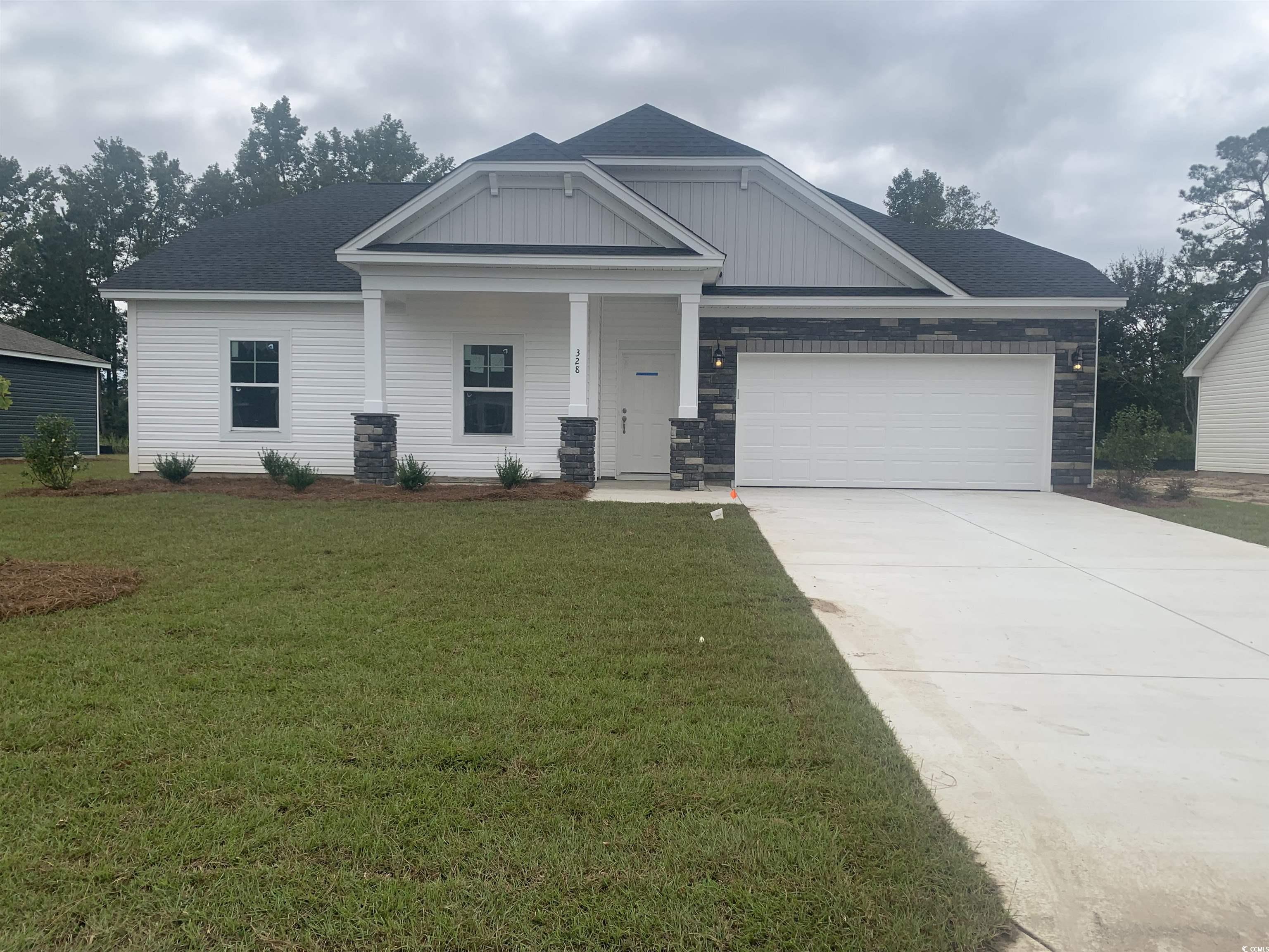 Craftsman-style house featuring a front yard, a ga