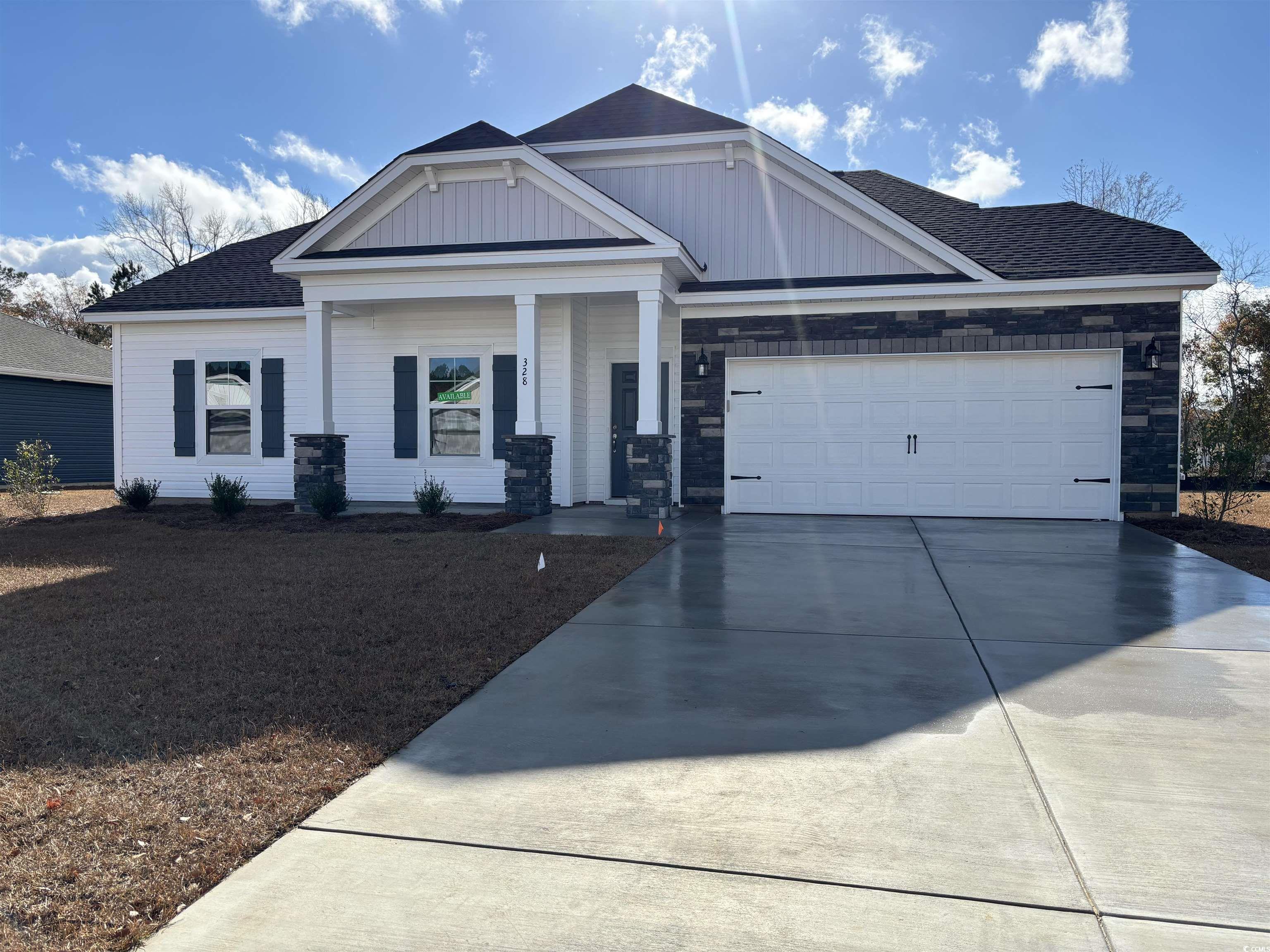 View of front of property with a porch and a garag