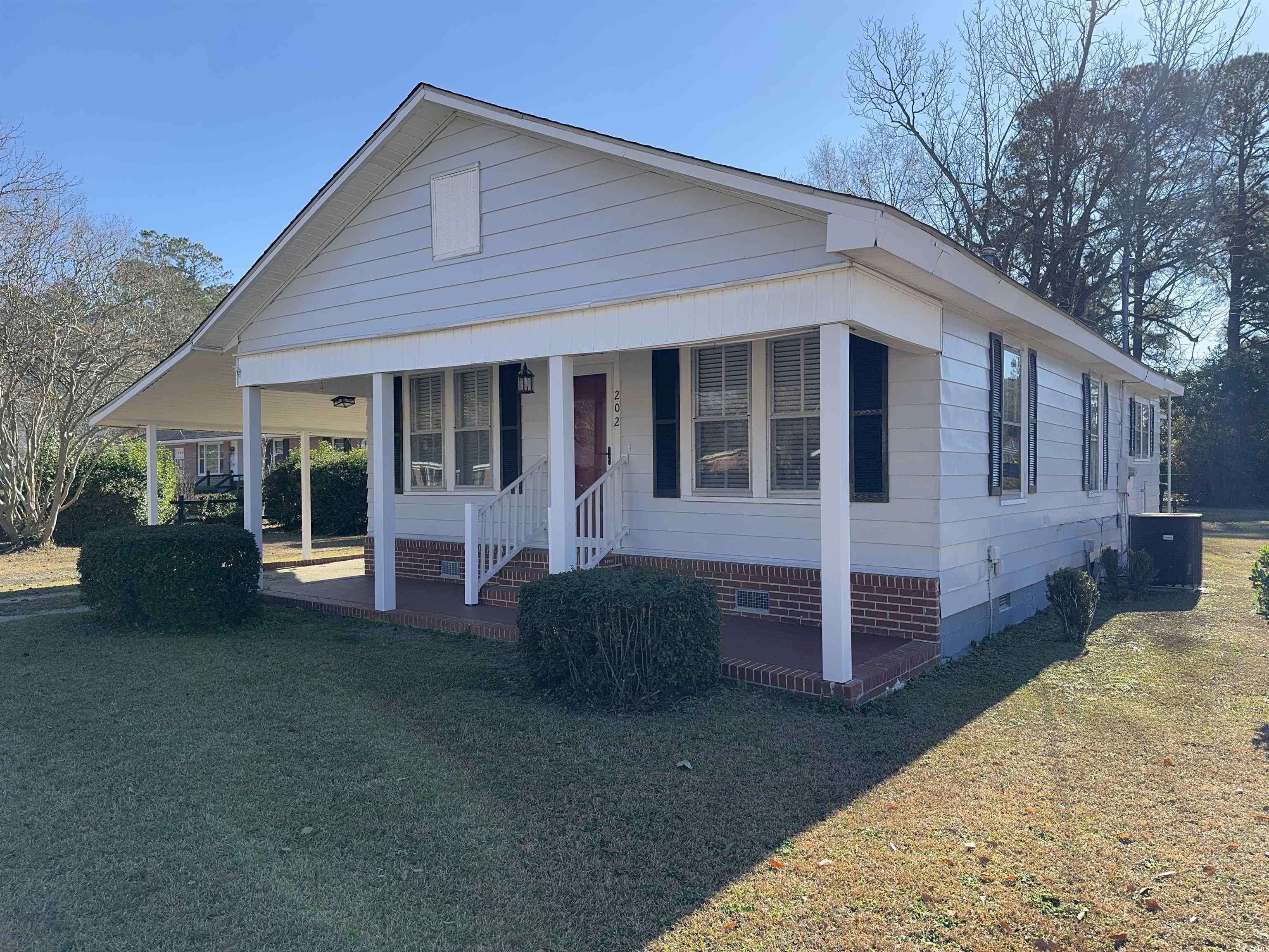 View of front facade featuring a porch, central ai