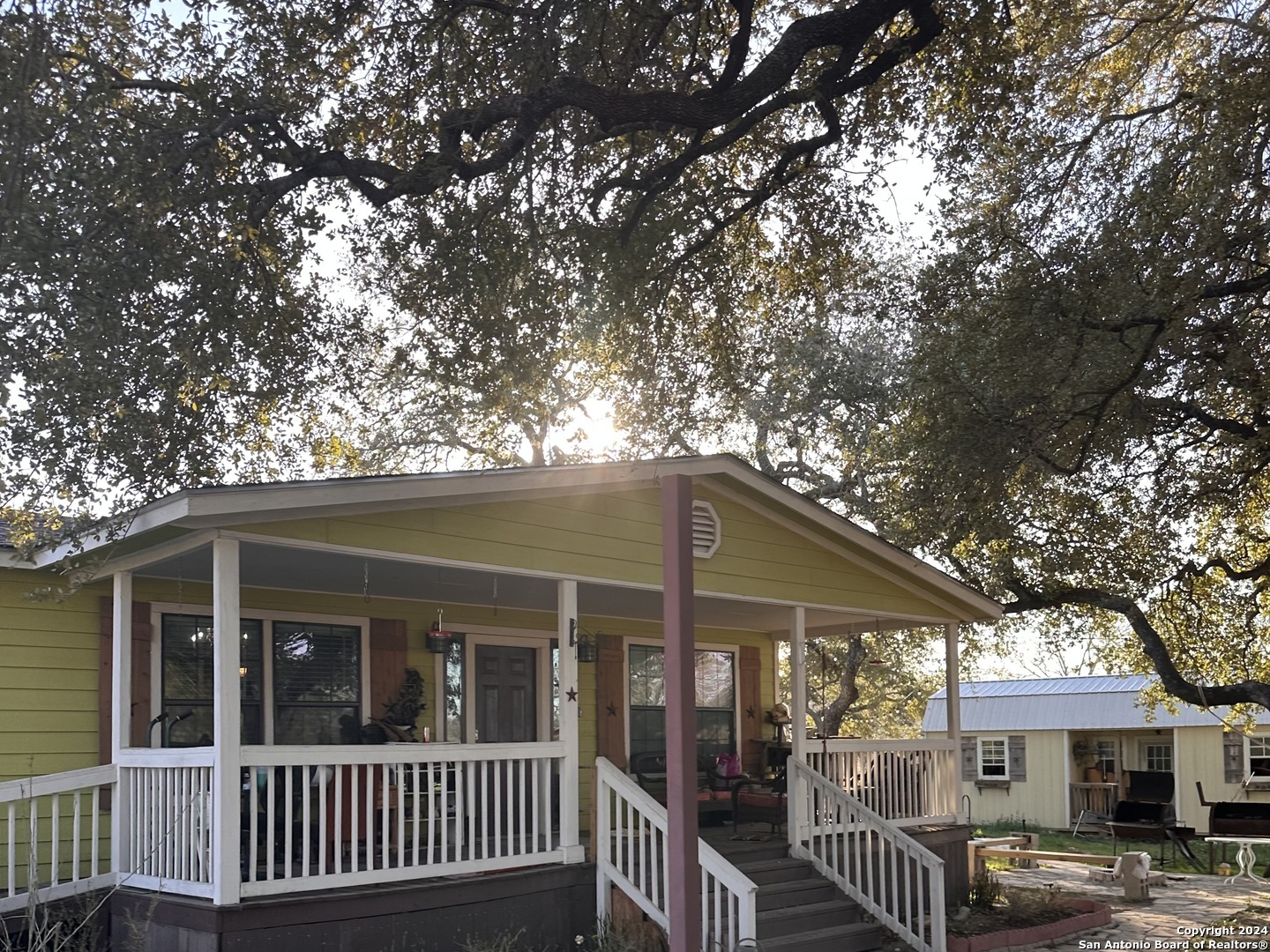 a view of a house with a tree in front of it