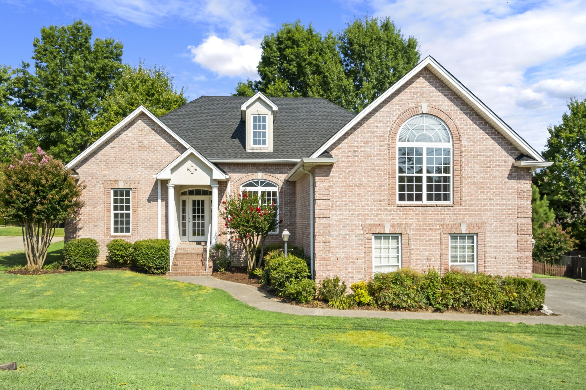 a front view of a house with a yard