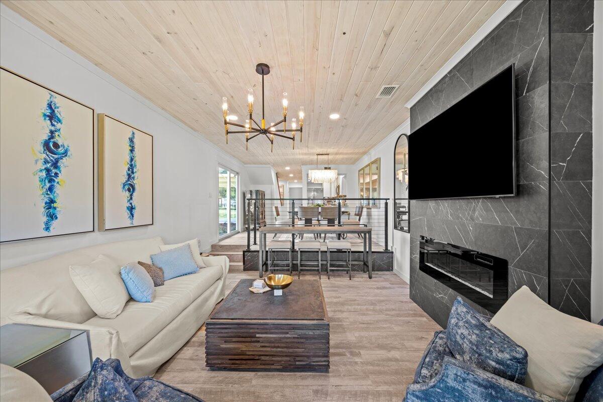 a living room with fireplace furniture and a flat screen tv