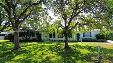 a view of a house with a tree in a yard