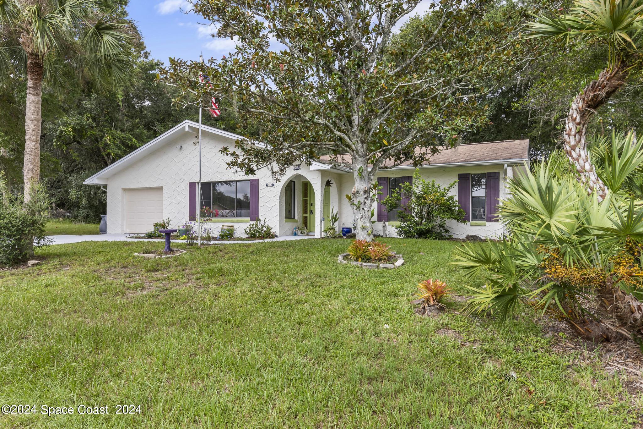 a front view of house with yard and green space