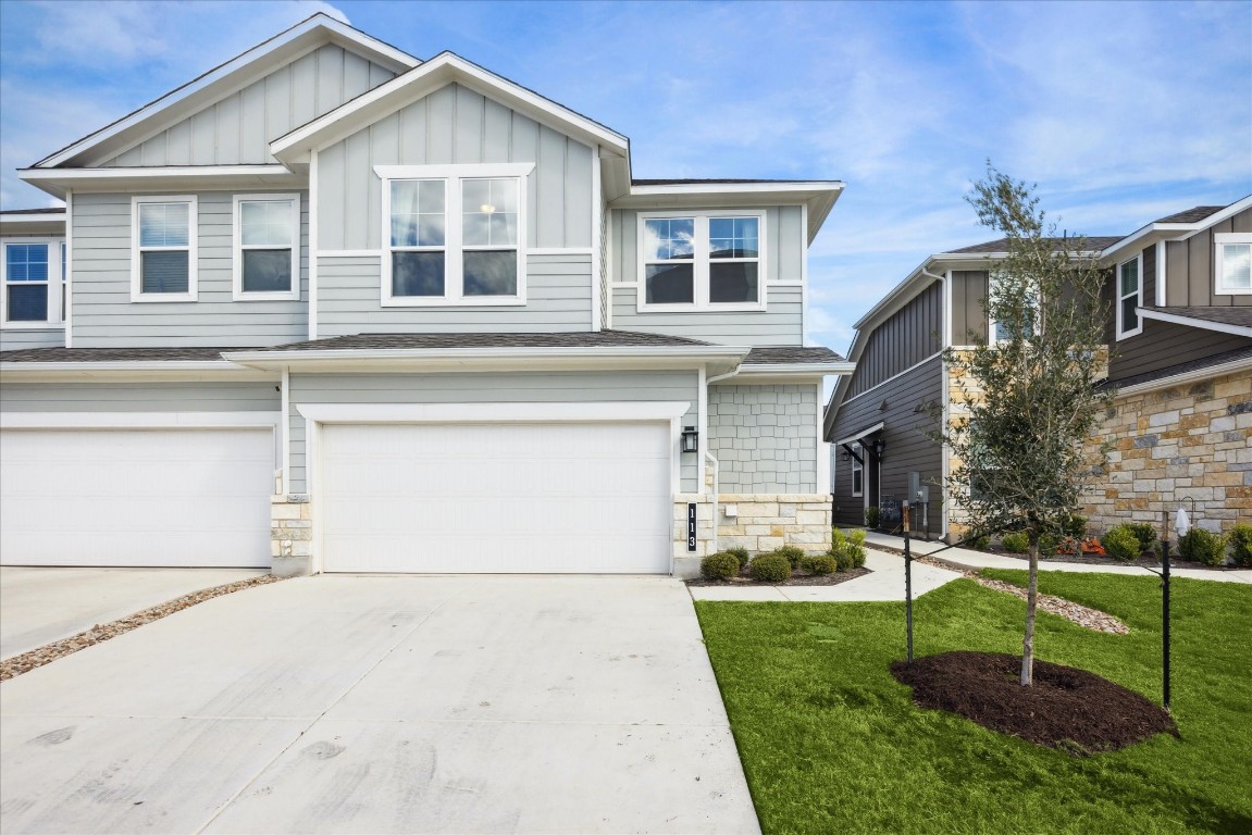 a front view of a house with a yard and garage