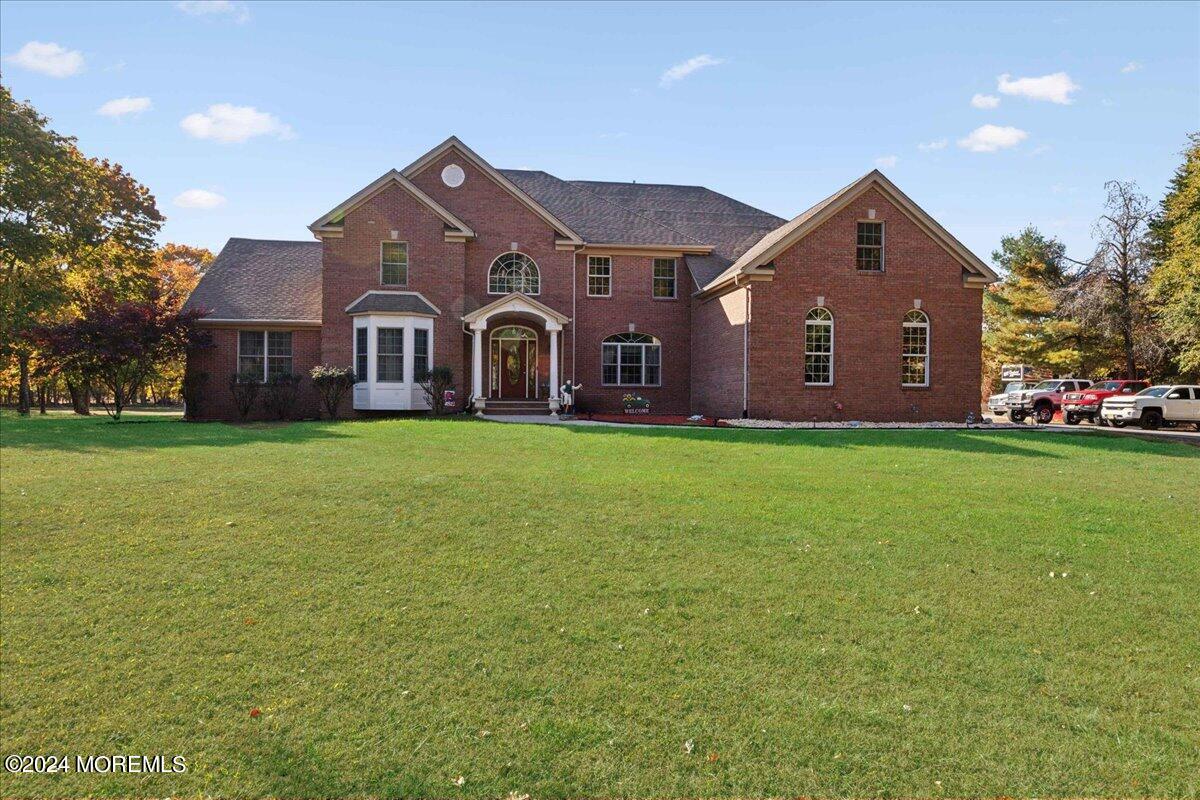 a front view of house with yard and green space