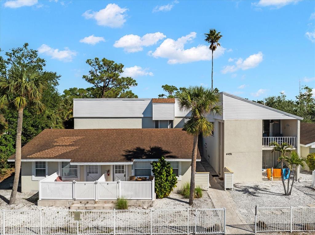 a view of a house with palm trees