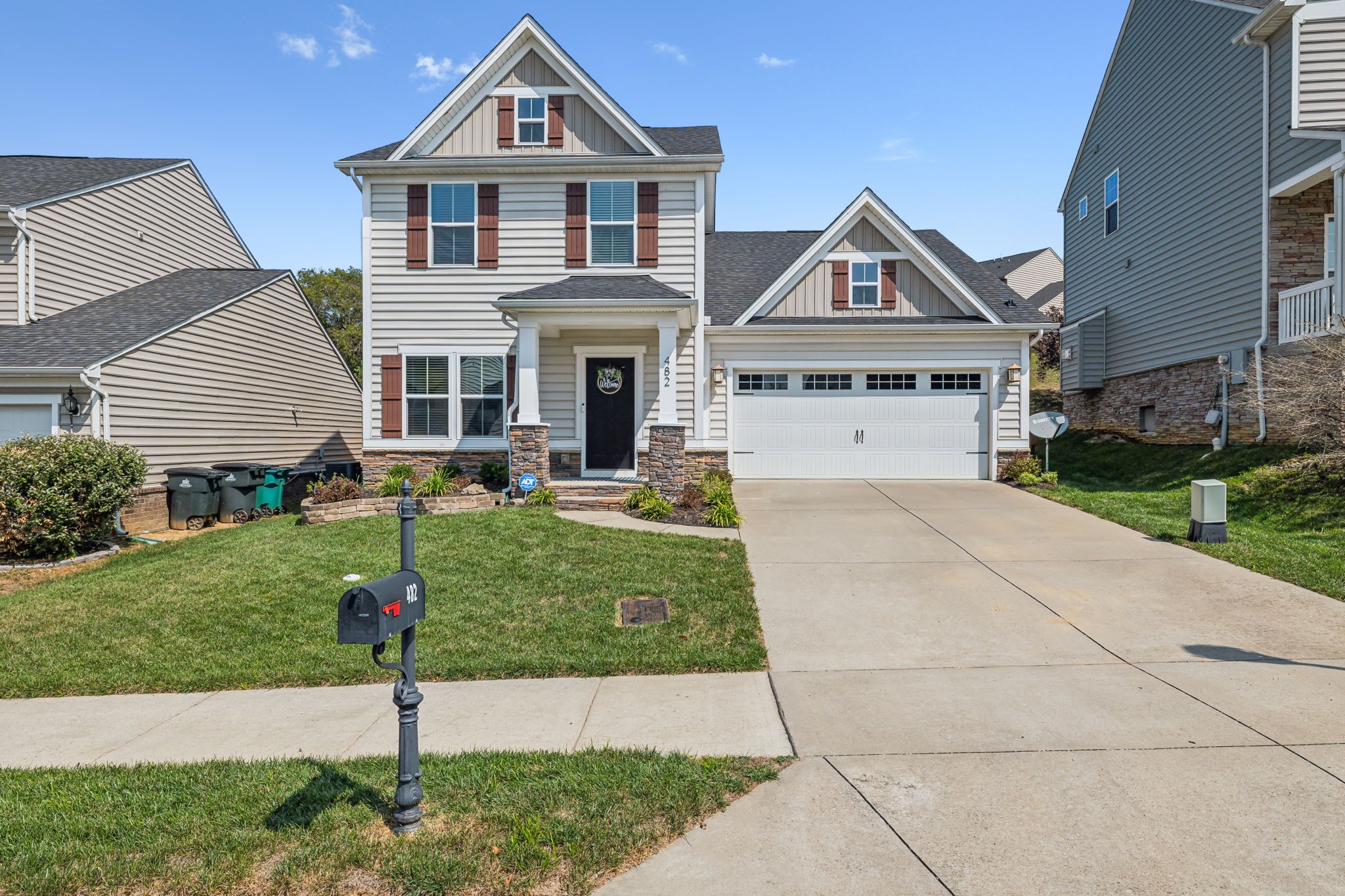 a front view of a house with a yard and garage