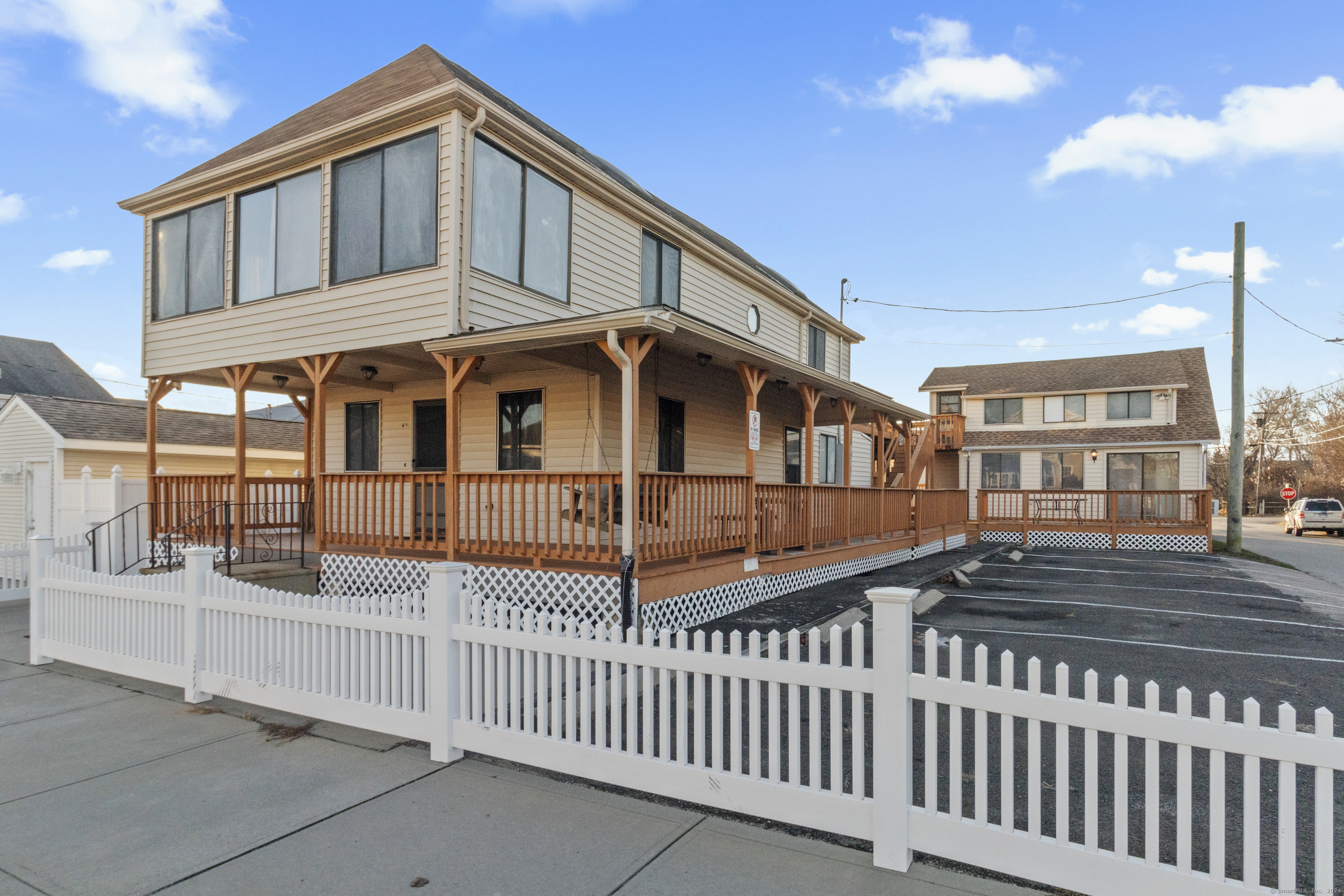 a view of a house with wooden fence