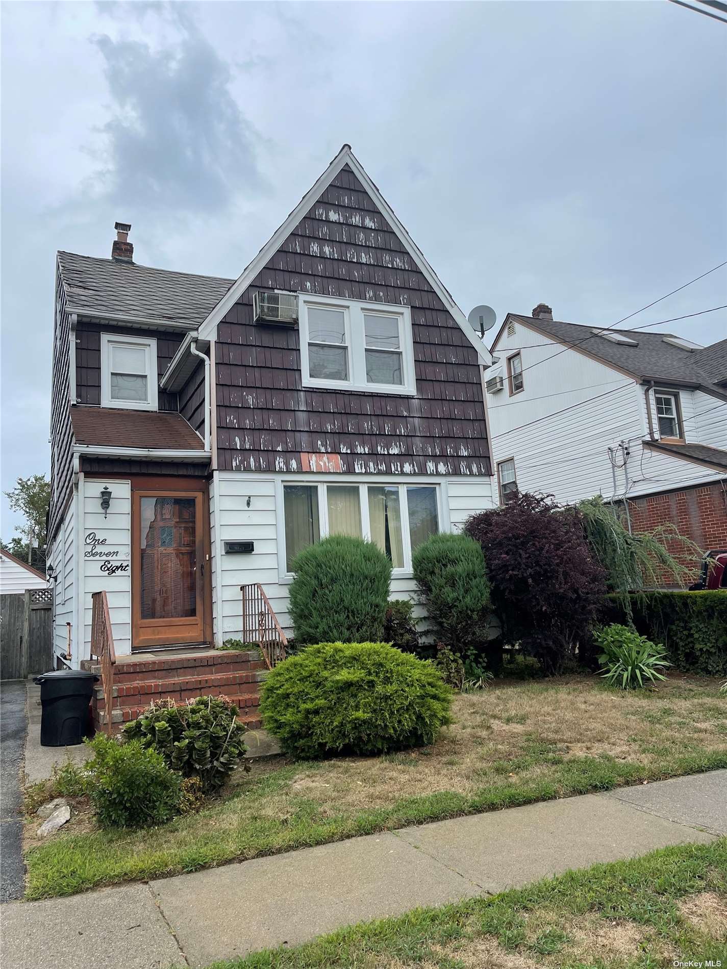 a front view of a house with a garden