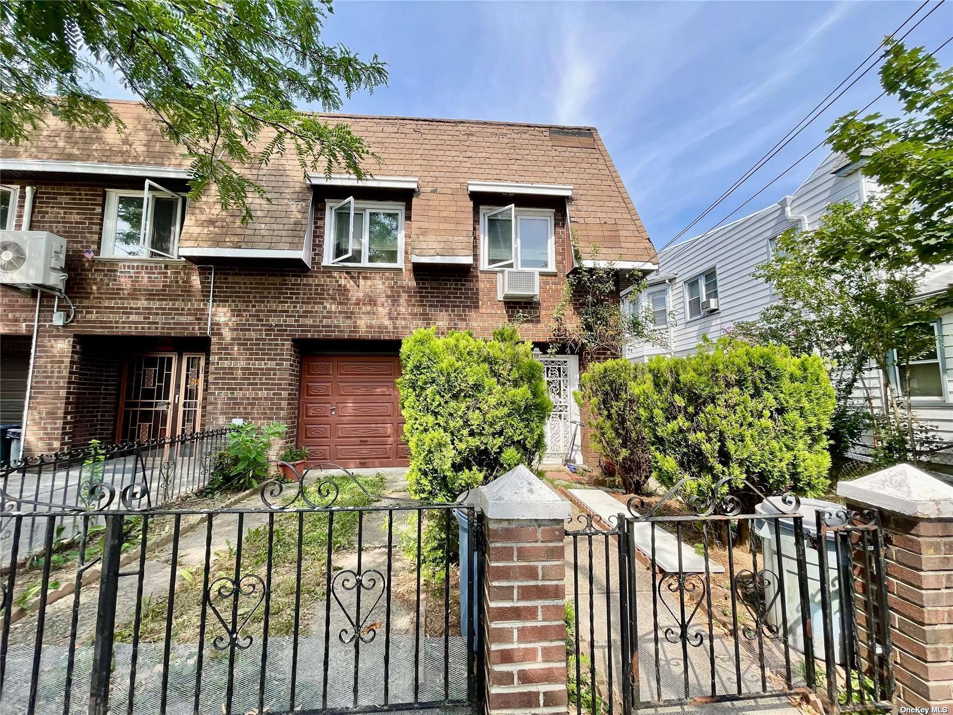 a front view of a house with a yard and potted plants