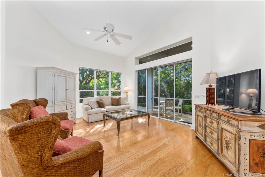 a living room with furniture large window and flat screen tv