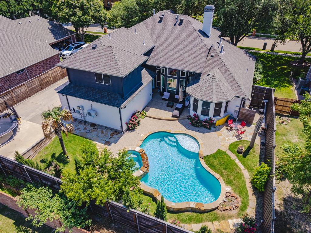 an aerial view of a house with outdoor space and pool