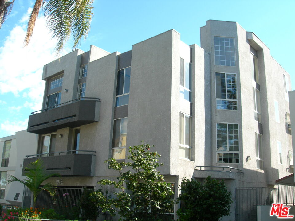 a front view of a building with a garden