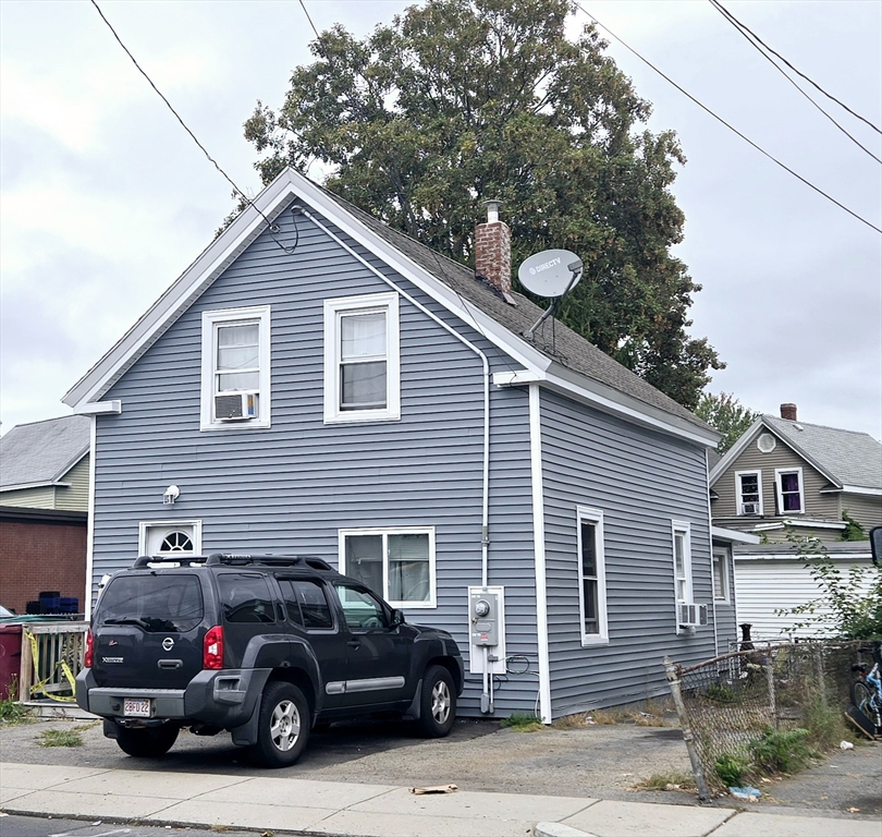 a view of a house and a car parked in front of house