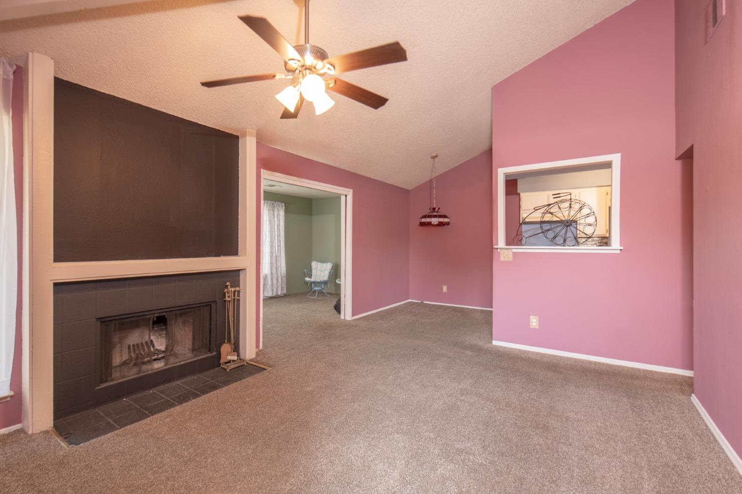 a view of an empty room with a fireplace