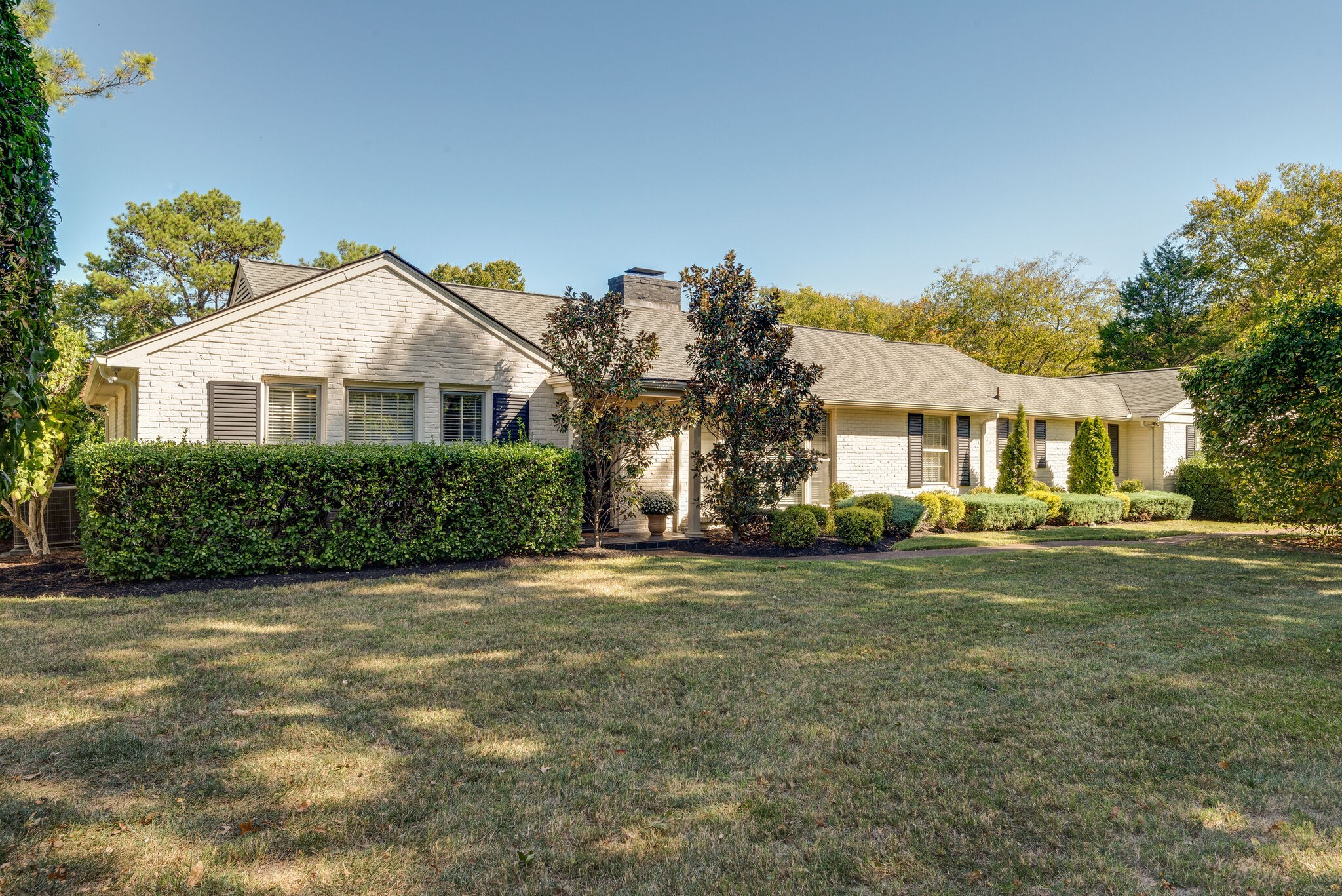 a front view of a house with a garden