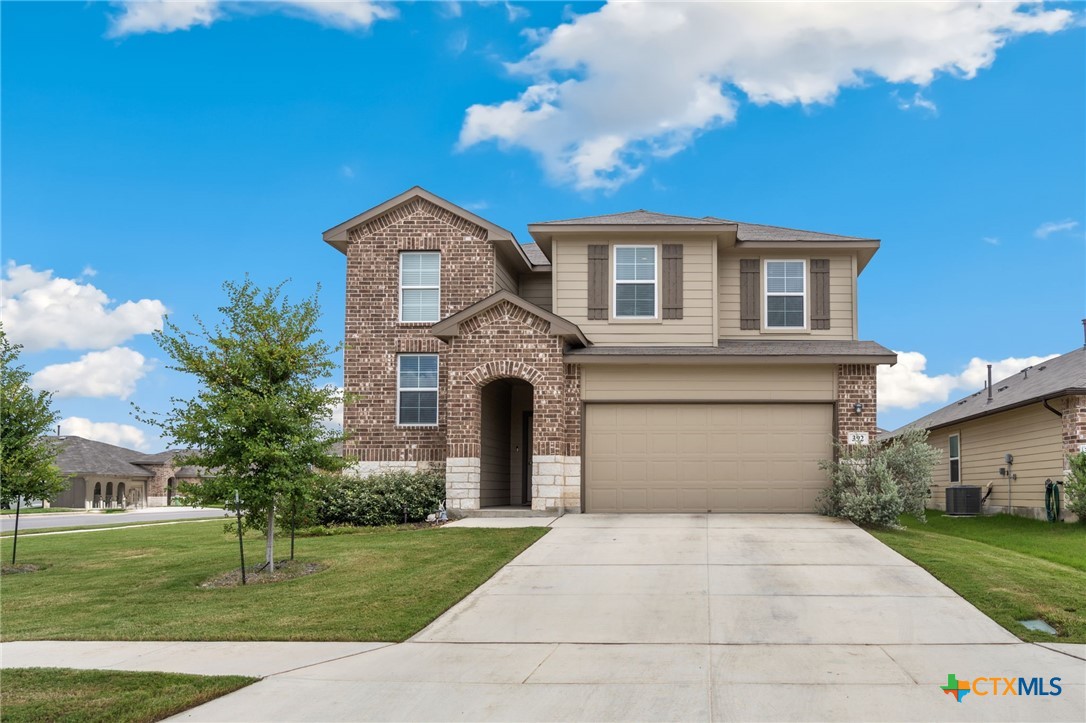 a front view of a house with a yard and garage