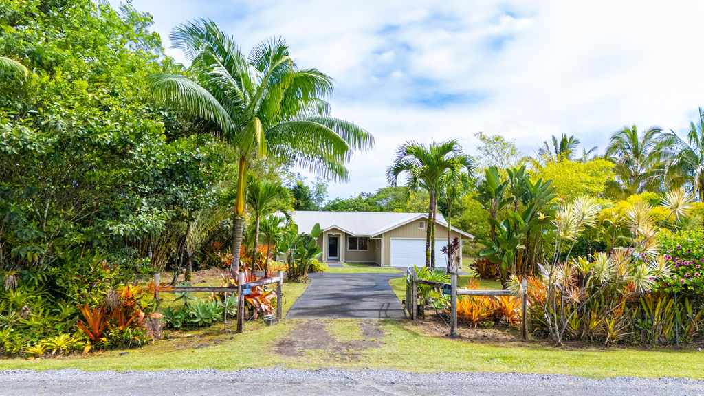 a front view of a house with garden